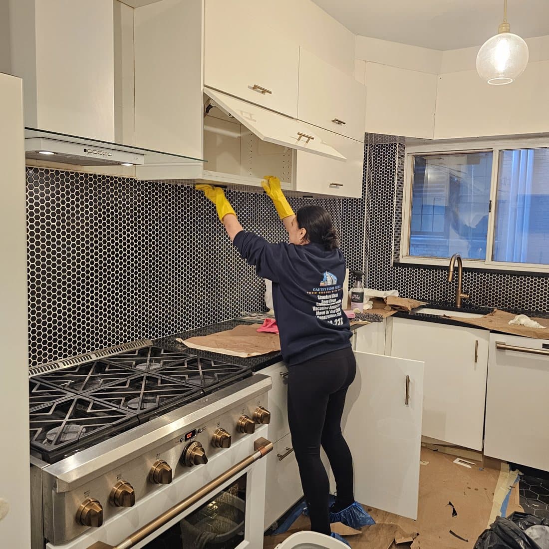 Gantry Prime Shine cleaner degreasing a tiled backsplash above a gas range