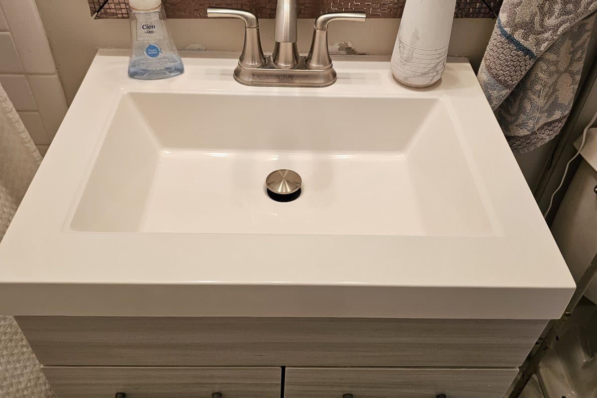 Clean modern white vanity sink with a brushed-nickel faucet